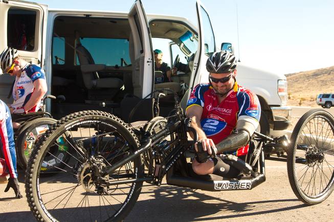John Masson, a U.S. Army Special Forces Veteran, prepares his 3-wheel hand-powered mountain bike, built by Bill Lasher of Las Vegas, for the Ride 2 Recovery Las Vegas Mountain Bike Challenge at Blue Diamond Monday, Jan. 27, 2014. Masson, who lost 3 limbs during a roadside bomb attack in Afghanistan in Oct. of 2010, is among many wounded veterans who are being helped by Ride 2 Recovery, a nonprofit organization that provides rehabilitation to injured veterans through cycling.